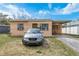 Front exterior showcasing a cozy single-story home with a car parked out front on a sunny day at 2501 Auburn S St, St Petersburg, FL 33712