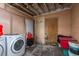 Indoor laundry room with white washer and dryer. Room in need of repairs at 2501 Auburn S St, St Petersburg, FL 33712