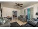 Inviting living room featuring tile floors, ceiling fan, two sofas, and access to other rooms at 2501 Auburn S St, St Petersburg, FL 33712