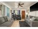 Comfortable living room with tile flooring, ceiling fan, sofas, chair, and a wooden front door at 2501 Auburn S St, St Petersburg, FL 33712
