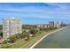 Stunning aerial view of a high-rise building along the Bayshore Boulevard waterfront with a beautiful blue sky backdrop at 2611 Bayshore Blvd # 605, Tampa, FL 33629