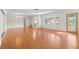 Spacious living room featuring gleaming hardwood floors, a modern chandelier, and large windows at 3051 37Th S Ave, St Petersburg, FL 33712