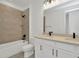 Modern bathroom featuring double vanity, tub, shower, and neutral tile at 32347 Wetland Bird Vw, San Antonio, FL 33576