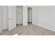 Bright, carpeted bedroom featuring open closet and doorways, white walls and trim at 32347 Wetland Bird Vw, San Antonio, FL 33576