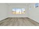 Bright bedroom featuring large windows and stylish wood-look floors at 32347 Wetland Bird Vw, San Antonio, FL 33576