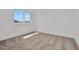 Bright bedroom with neutral carpeting, white walls and trim and a large window at 32347 Wetland Bird Vw, San Antonio, FL 33576