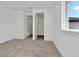 Bright bedroom with carpeted floor, closet, and abundant natural light from the window at 32347 Wetland Bird Vw, San Antonio, FL 33576