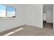 Well-lit bedroom with neutral carpeting and a bright window, featuring white walls and trim at 32347 Wetland Bird Vw, San Antonio, FL 33576