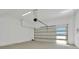 Spacious garage with an automatic door and concrete floor ready for vehicles and storage at 32347 Wetland Bird Vw, San Antonio, FL 33576