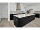 Bright kitchen featuring a large island, stainless hood vent, and modern cabinetry at 32347 Wetland Bird Vw, San Antonio, FL 33576