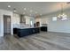 Modern kitchen with white and black cabinets, a large island, and stylish lighting fixtures at 32347 Wetland Bird Vw, San Antonio, FL 33576