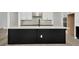A large kitchen island with black cabinets, a white countertop, and a modern faucet at 32347 Wetland Bird Vw, San Antonio, FL 33576