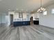 A modern kitchen with white cabinets, a black island, and stainless steel appliances at 32347 Wetland Bird Vw, San Antonio, FL 33576