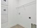 Bright laundry room features durable tile floors and a convenient overhead storage rack at 32347 Wetland Bird Vw, San Antonio, FL 33576
