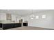 Spacious living room area with a kitchen featuring a large island and stainless steel hood at 32347 Wetland Bird Vw, San Antonio, FL 33576