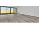 Bright living room with modern flooring and a seamless transition to outdoor living spaces at 32347 Wetland Bird Vw, San Antonio, FL 33576