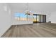Bright living space with big windows, and modern chandelier with views of the backyard at 32347 Wetland Bird Vw, San Antonio, FL 33576