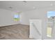 Spacious loft area with neutral carpet and bright natural light from multiple windows at 32347 Wetland Bird Vw, San Antonio, FL 33576