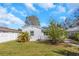 Backyard with a well-manicured lawn, a patio, a fence, and mature landscaping at 356 Ridge Sw Rd, Largo, FL 33770