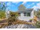 Charming home exterior featuring light-colored stucco, a well-kept yard, and beautiful landscaping at 356 Ridge Sw Rd, Largo, FL 33770