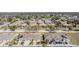 Aerial view of a residential neighborhood, featuring rows of homes and tree-lined streets at 37850 Prairie Rose Loop, Zephyrhills, FL 33542