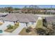 Aerial view of a well-maintained home with a manicured lawn, complemented by a pristine white fence at 37850 Prairie Rose Loop, Zephyrhills, FL 33542