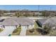 Aerial view of a well-maintained home, featuring green lawns, and a clean white fence at 37850 Prairie Rose Loop, Zephyrhills, FL 33542