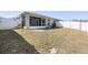 Wide shot showing the screened in porch, fenced yard, and grassy area at 37850 Prairie Rose Loop, Zephyrhills, FL 33542