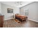Bedroom with wood look flooring, painting on wall, and an upholstered twin bed at 37850 Prairie Rose Loop, Zephyrhills, FL 33542