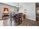 Cozy dining area featuring dark wood floors, gray walls, and a square table with matching chairs at 37850 Prairie Rose Loop, Zephyrhills, FL 33542