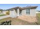 Charming neutral color scheme, one-car garage, and decorative rock landscaping at 37850 Prairie Rose Loop, Zephyrhills, FL 33542
