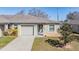 Charming single-story home featuring an attached garage, well-maintained lawn, and manicured landscaping at 37850 Prairie Rose Loop, Zephyrhills, FL 33542