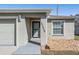 Home exterior with neutral color scheme, decorative rock landscaping, and well kept front lawn at 37850 Prairie Rose Loop, Zephyrhills, FL 33542
