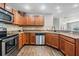 Kitchen boasts granite countertops, stainless steel appliances, and tile flooring at 37850 Prairie Rose Loop, Zephyrhills, FL 33542