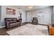 Open-concept living room features wood-look tile flooring, neutral walls, and lots of natural light at 37850 Prairie Rose Loop, Zephyrhills, FL 33542