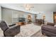 Inviting living room featuring lots of natural light, wood-look tile flooring, and ceiling fan at 37850 Prairie Rose Loop, Zephyrhills, FL 33542