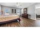 Bedroom featuring wood floors, neutral walls, and window views, creating a bright and airy feel at 37850 Prairie Rose Loop, Zephyrhills, FL 33542