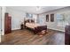 Bedroom with wood-look floors, ceiling fan, and bright windows, offering a serene and comfortable space at 37850 Prairie Rose Loop, Zephyrhills, FL 33542