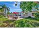 Expansive backyard featuring a pool, patio with dining set, and well-maintained lawn, great for entertaining at 4711 Travertine Dr, Tampa, FL 33615