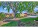 Lush green backyard with mature trees, a brick patio with a table set, and a privacy fence at 4711 Travertine Dr, Tampa, FL 33615