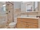 Bathroom with tile surround shower, single sink vanity, and tile floors at 4711 Travertine Dr, Tampa, FL 33615