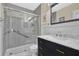 Bathroom featuring sleek gray tile, frameless shower, and a modern vanity with marble countertop at 4711 Travertine Dr, Tampa, FL 33615