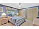 Comfortable bedroom with blue walls, featuring a large window and ample natural light at 4711 Travertine Dr, Tampa, FL 33615
