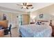 Cozy bedroom with ceiling fan, with an ensuite bathroom for added convenience at 4711 Travertine Dr, Tampa, FL 33615