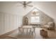 Upstairs bonus room with a round table and chairs, window, custom shelving, and decorative items at 4711 Travertine Dr, Tampa, FL 33615