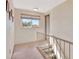 Upstairs hallway with window and carpet at 4711 Travertine Dr, Tampa, FL 33615