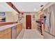 Well-equipped kitchen featuring stainless steel appliances, light cabinetry, and tiled backsplash at 4711 Travertine Dr, Tampa, FL 33615