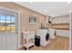 Functional laundry room with modern washer and dryer, sink and ample storage at 4711 Travertine Dr, Tampa, FL 33615