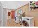 Laundry area featuring a washer, dryer, storage and view to the kitchen at 4711 Travertine Dr, Tampa, FL 33615
