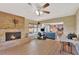 Bright living room showcasing a stone fireplace, hardwood floors, and open access to other rooms at 4711 Travertine Dr, Tampa, FL 33615